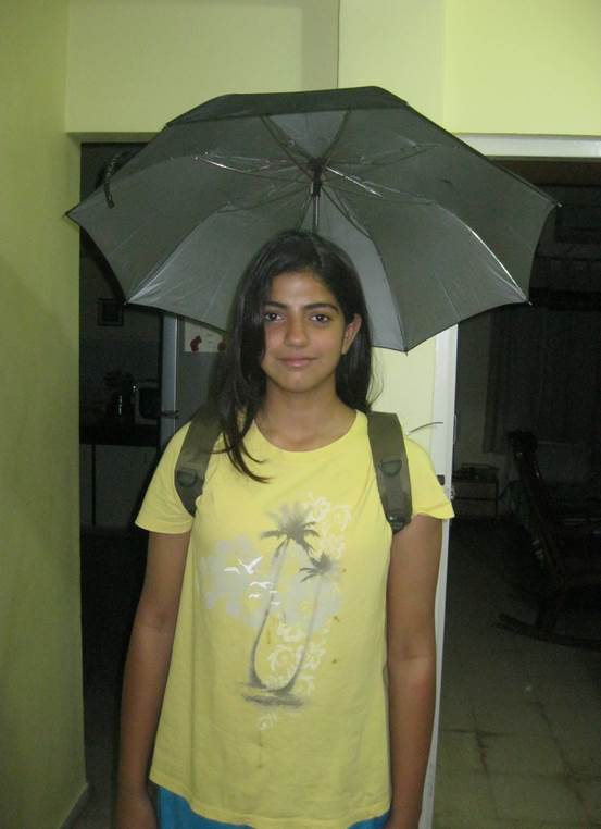 A young girl wears her invention, a wearable umbrella