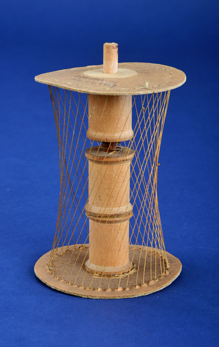 Hyperboloid model made of cardboard, wood, thread, wire, and thread spools