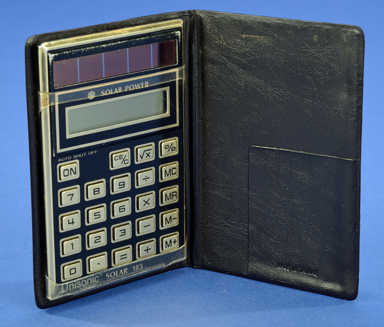 Unisonic Solar 185 handheld electronic calculator in folding pocket case, about 1983. Solar panels are above number display