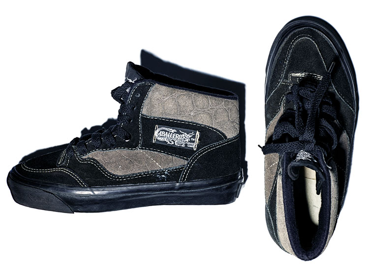 Vans black and grey suede hi-top skateboarding shoes with a black suede toe and eyestay, black midsoles, and the trademark deep tan, waffle pattern soles. 