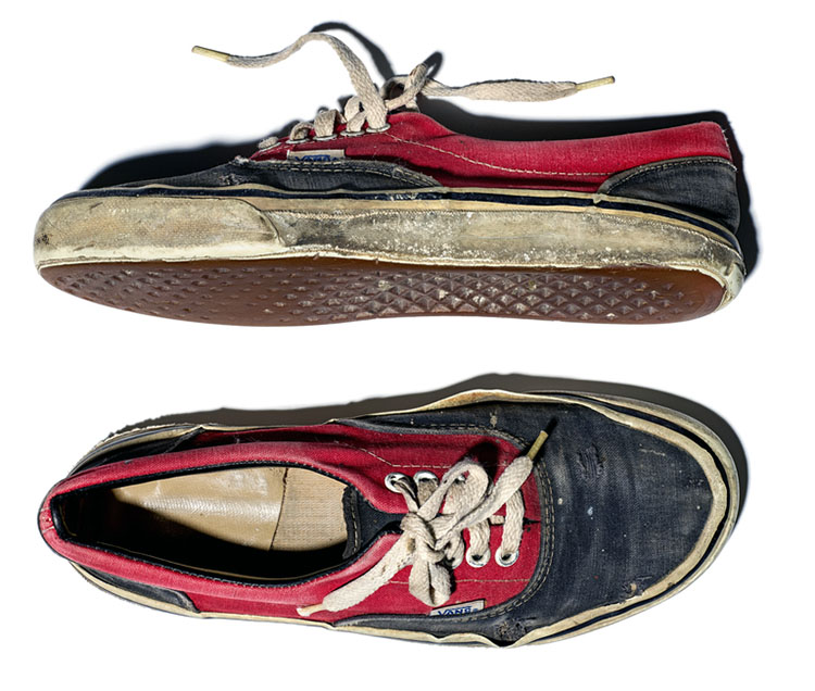 Vans blue and red low top skateboarding shoes with white midsoles and the trademark deep tan, waffle pattern.