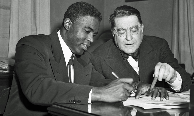 Jackie Robinson signing contract with Branch Rickey