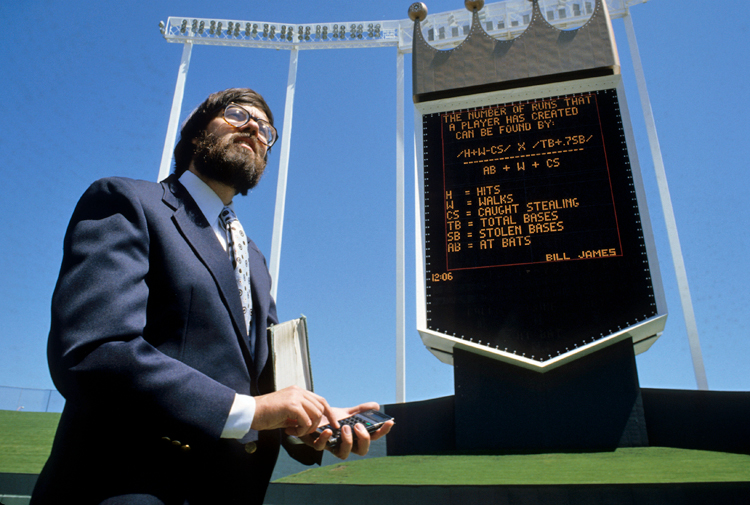 Bill James in foreground with large digital display in background