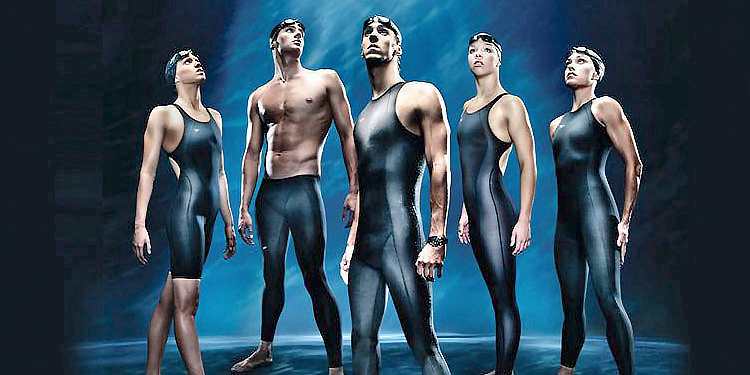 5 swimmers wearing LZR suits, shoulders back, gazing skyward.