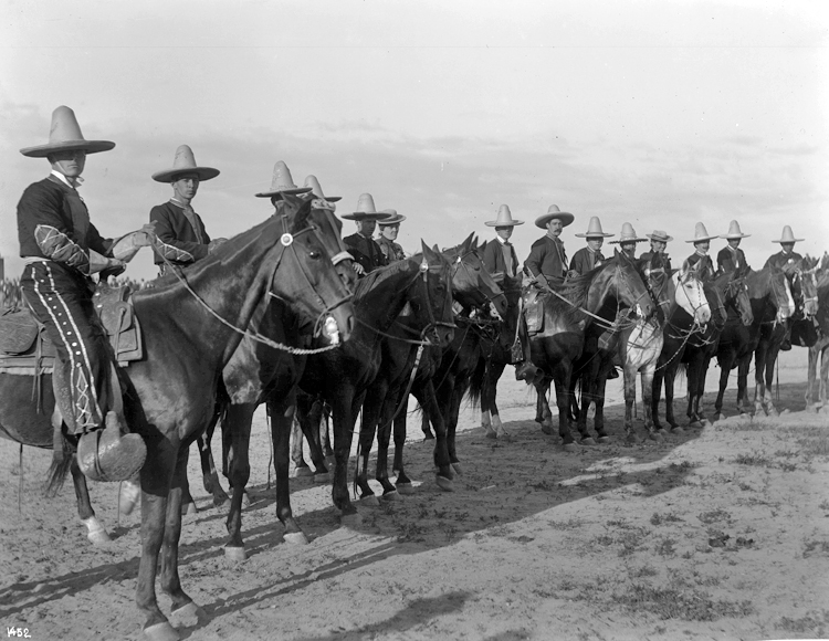 About 15 members of the Plummer’s Vaquero Club, sitting on horses and wearing vaquero costumes and 10-gallon hats, Los Angeles, 1901