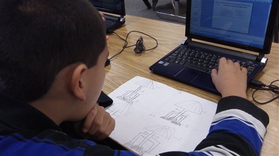 A student uses CAD software on a laptop