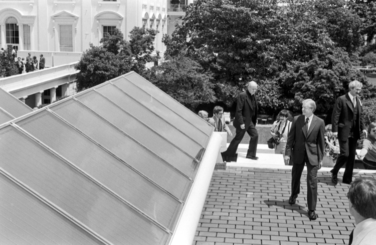 President Jimmy Carteron the roof of the White House inspecting solar thermal panels, 1979