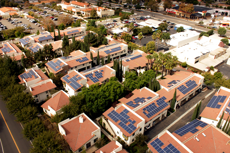 Aerial view of olar panels installed on many rooftops
