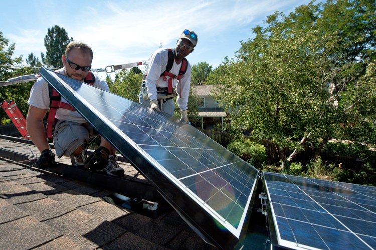 Workers installing solar panels on a home in Englewood, Colorado, 2012