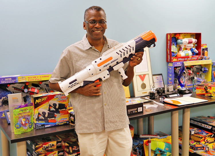 Lonnie Johnson with Super Soaker and Nerf toys.