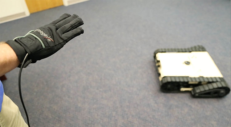 Close-up of AnthroTronix employee's hand in a glove used to control a robot