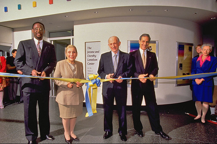 Four people cutting a ceremonial ribbon