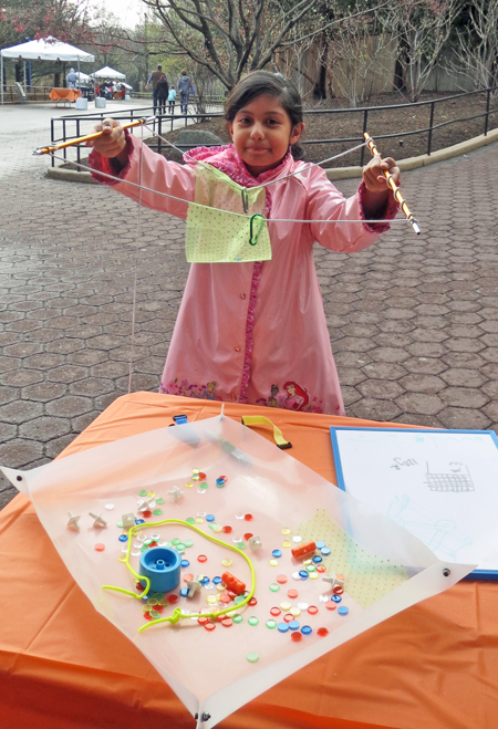 Young girl holding up her invention