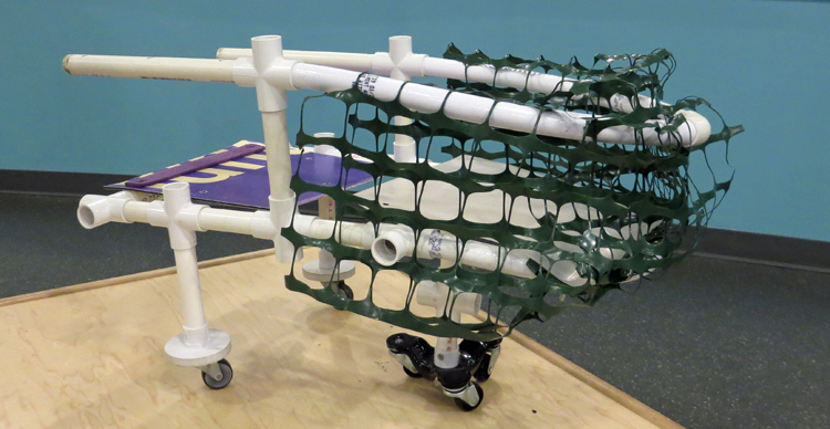 A shopping cart made of PVC pipes, plastic wheels, and plastic net fencing.