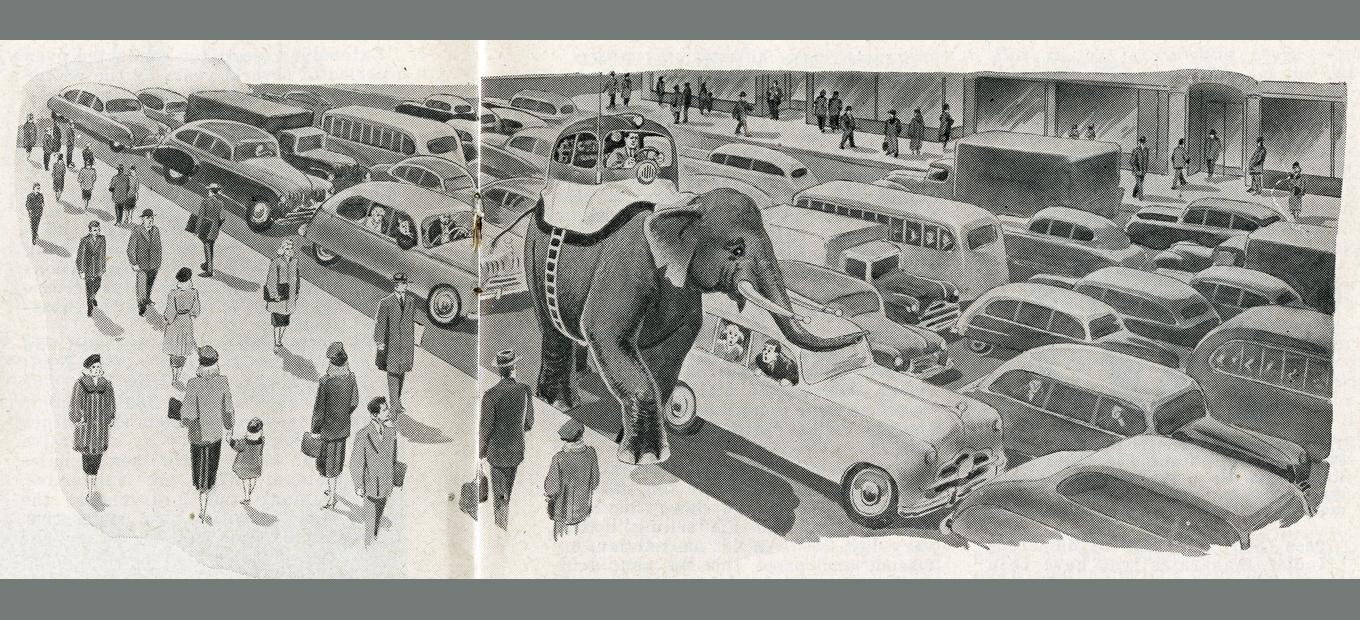 Spoof design for the passenger compartment of a car strapped, complete with driver and steering wheel, atop an elephant, making its way down a crowded city street while amazed pedestrians and other drivers look on.