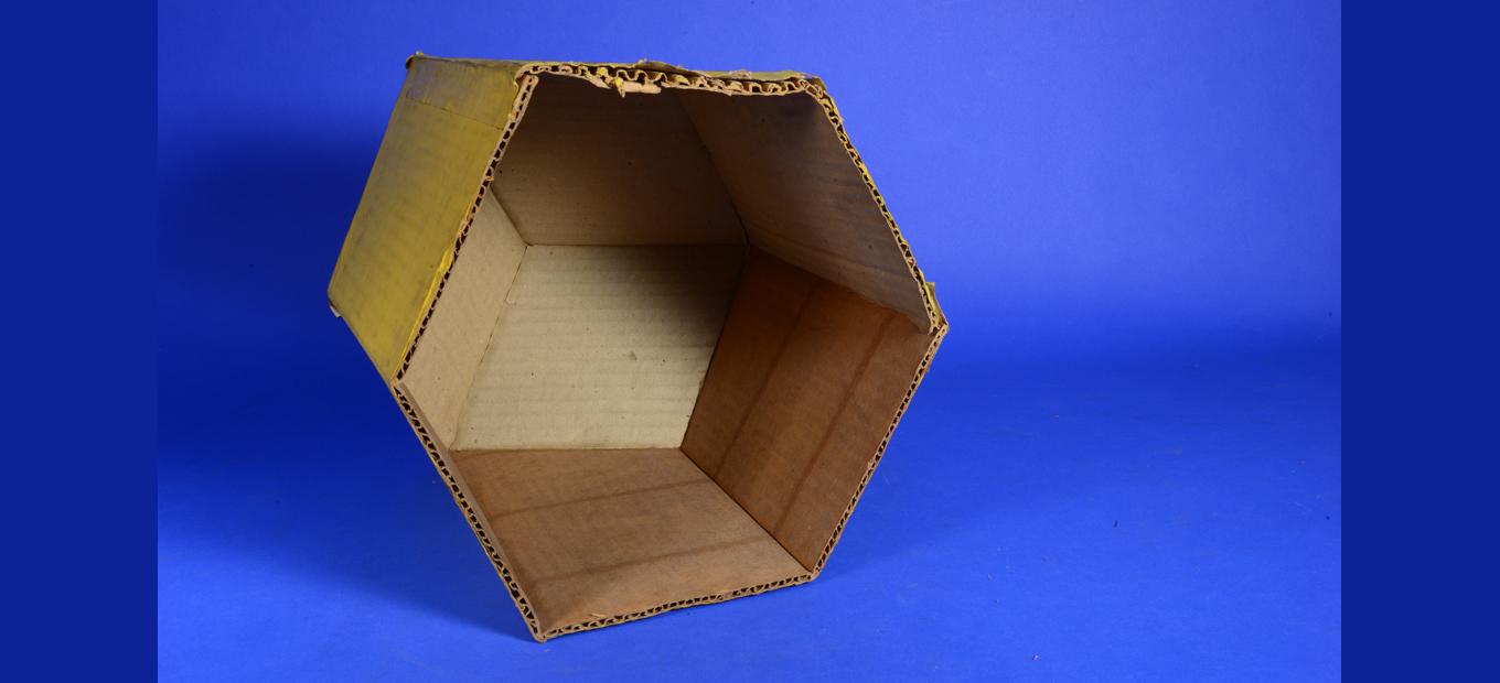 Open bottom of a cardboard model, with corrugation of cardboard visible.