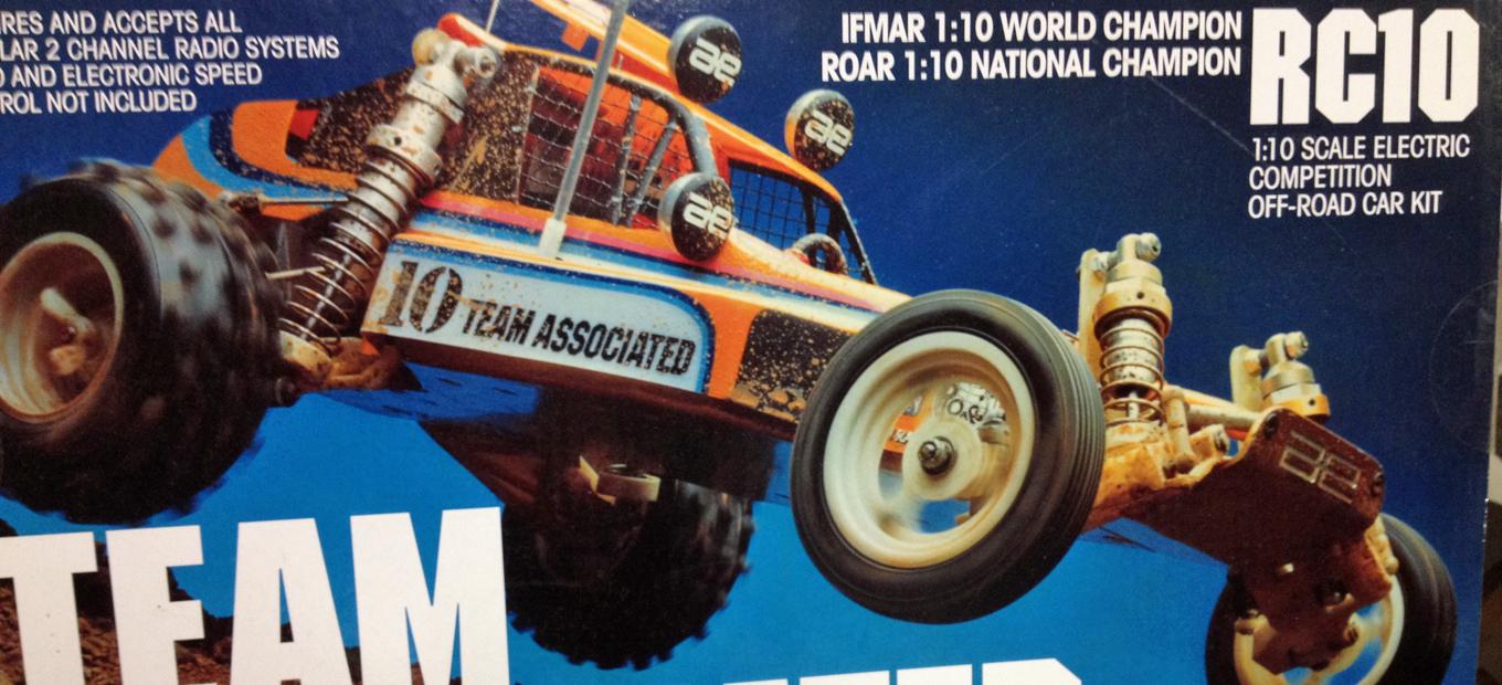 Cover of box from Team Associated RC10 kit re-release showing car in profile and airborne