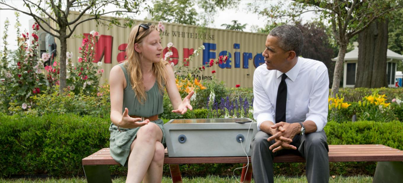 President Barack Obama chats with inventor Sandra Richter, whose solar-powered park bench allows users to charge their mobile devices.