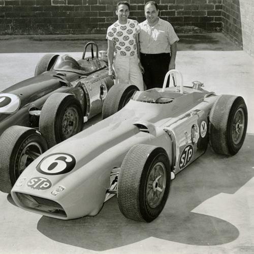 Andy Granatelli and his brother Vincent standing behind two race cars