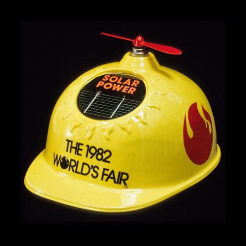 Yellow plastic hard hat with solar-powered propeller on top, souvenir from, Knoxville World’s Fair, 1982