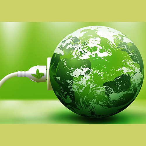 A planet earth globe with a green-hue is being plugged into a USB outlet.