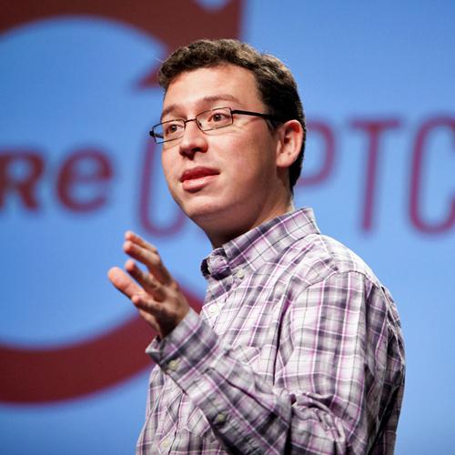 Luis von Ahn stands in front of a large red ReCAPTCHA logo while speaking at the 2009 Pop!Tech conference in Camden, Maine.