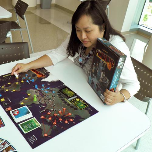A young woman playing Pandemic