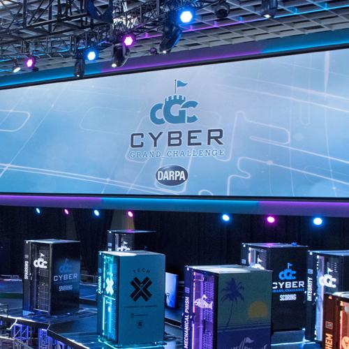 Competing systems on stage at the DARPA Cyber Grand Challenge, 2016
