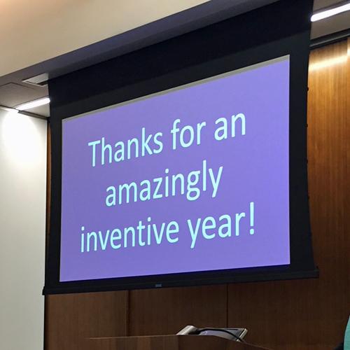 The words Thanks for an amazingly inventive year! are visible on a projection screen.